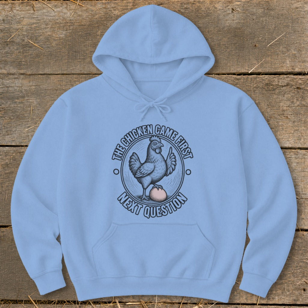 Light blue hoodie with a graphic of a chicken on an egg and text "THE CHICKEN CAME FIRST NEXT QUESTION".