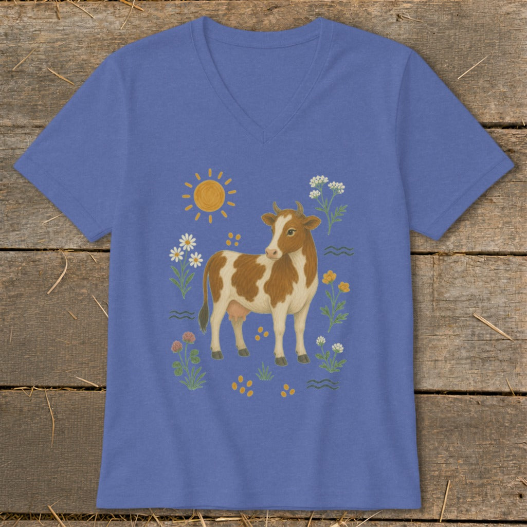 Blue v-neck t-shirt with a brown and white cow surrounded by flowers and sun.