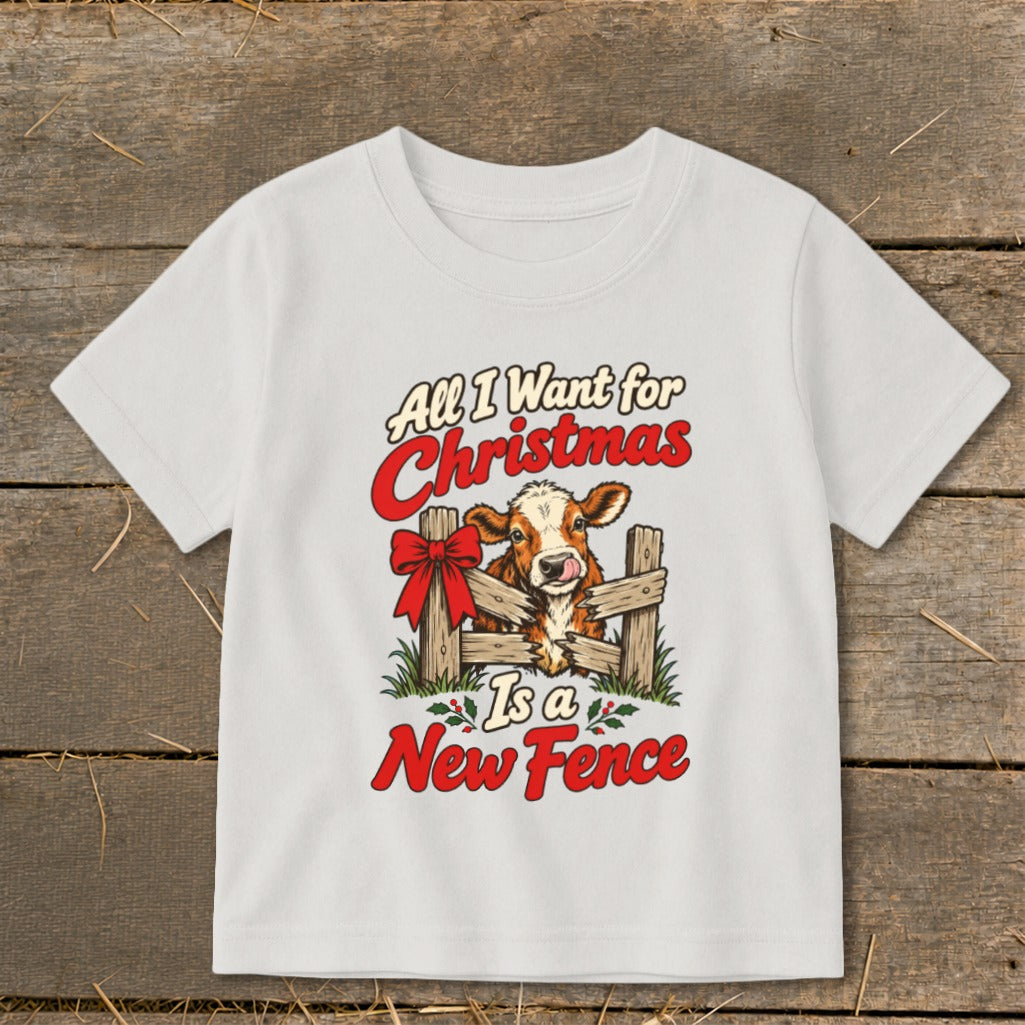 White t-shirt with a cow behind a fence and text "All I Want for Christmas is a New Fence".