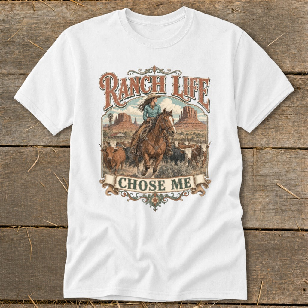 White t-shirt graphic of cowgirl riding horse with cattle and text "Ranch Life Chose Me."