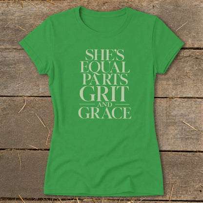 Green t-shirt with light grey text reading "SHE'S EQUAL PARTS GRIT AND GRACE".