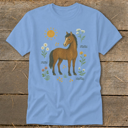 Light blue t-shirt with a brown horse surrounded by flowers, sun, and water.
