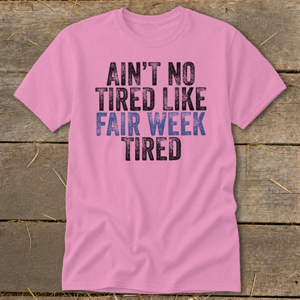 Pink t-shirt with text "Ain't No Tired Like Fair Week Tired".