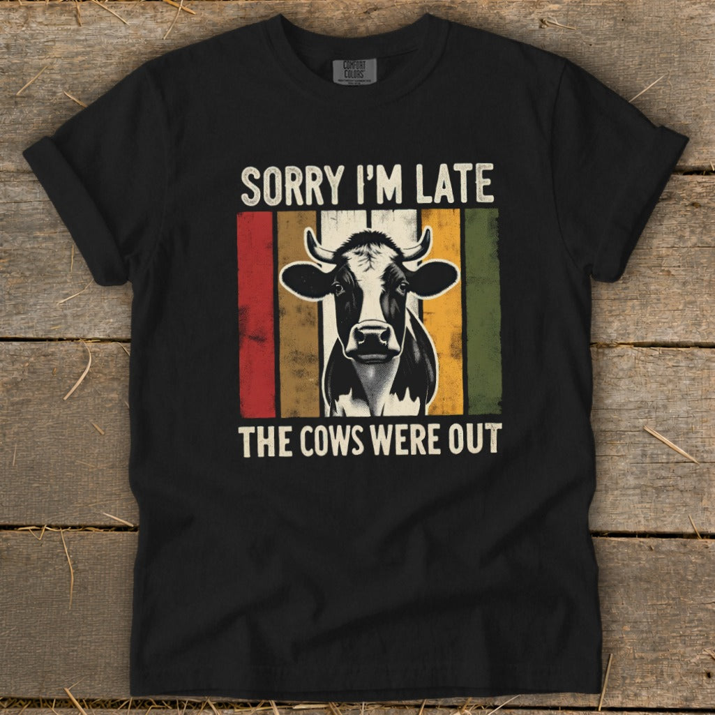 Black t-shirt with a cow graphic and text "Sorry I'm Late The Cows Were Out".