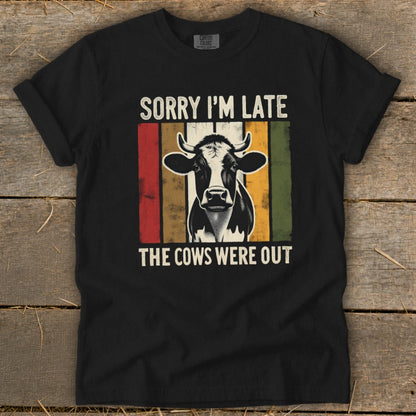 Black t-shirt with a cow graphic and text "Sorry I'm Late The Cows Were Out".