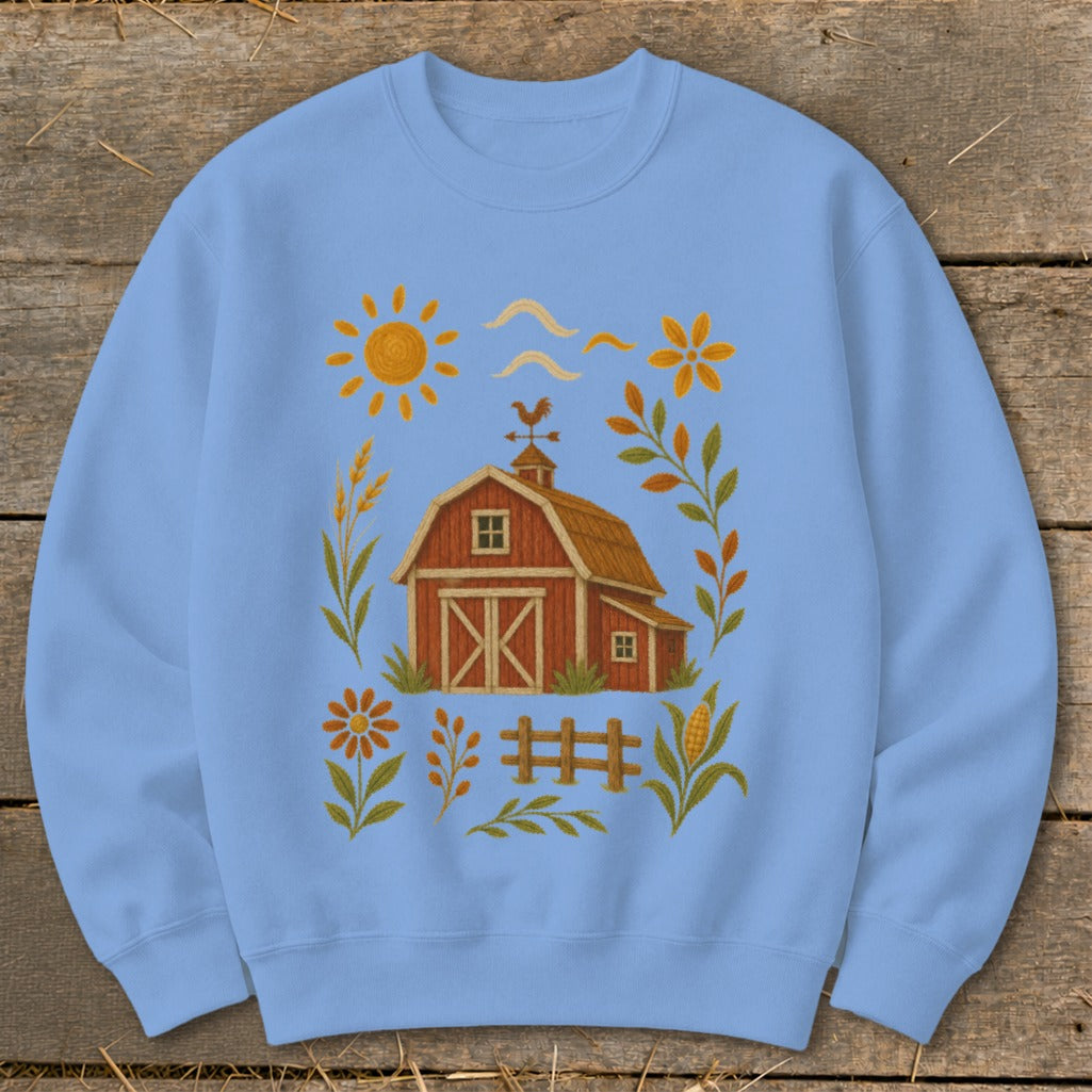 Light blue sweatshirt with a barn, sun, flowers, and corn illustration.