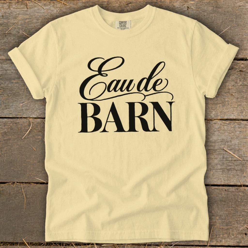 Light yellow t-shirt with black text reading "Eau de BARN"
