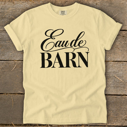 Light yellow t-shirt with black text reading "Eau de BARN"