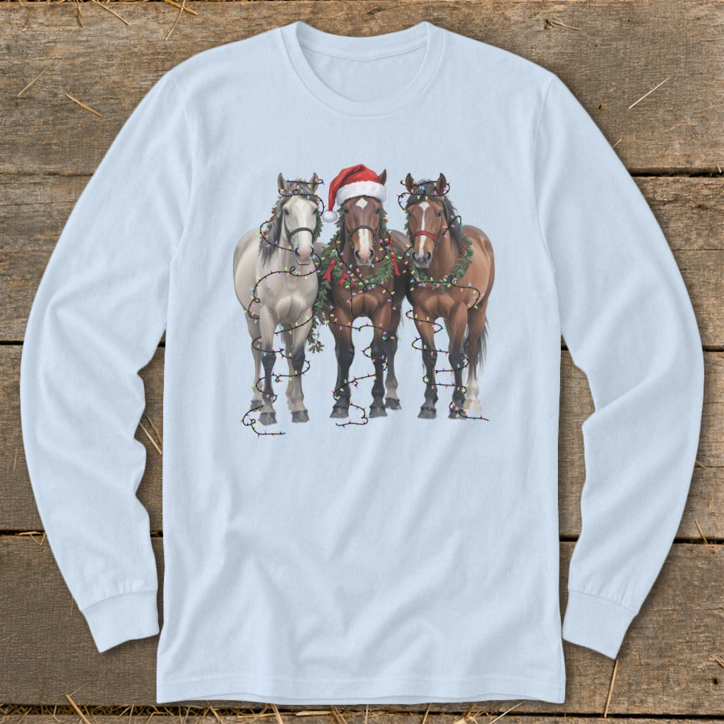 Three horses wearing Santa hats and Christmas lights and garlands.