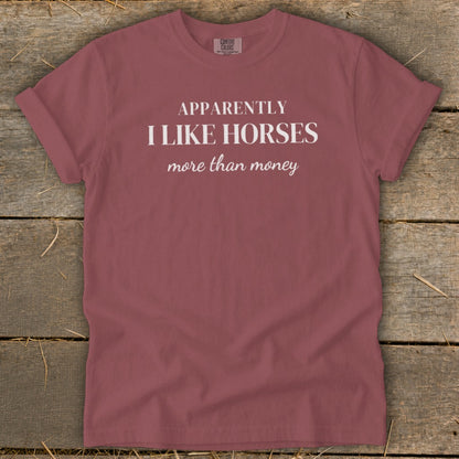 Rose t-shirt with white text that reads "Apparently I Like Horses more than money."