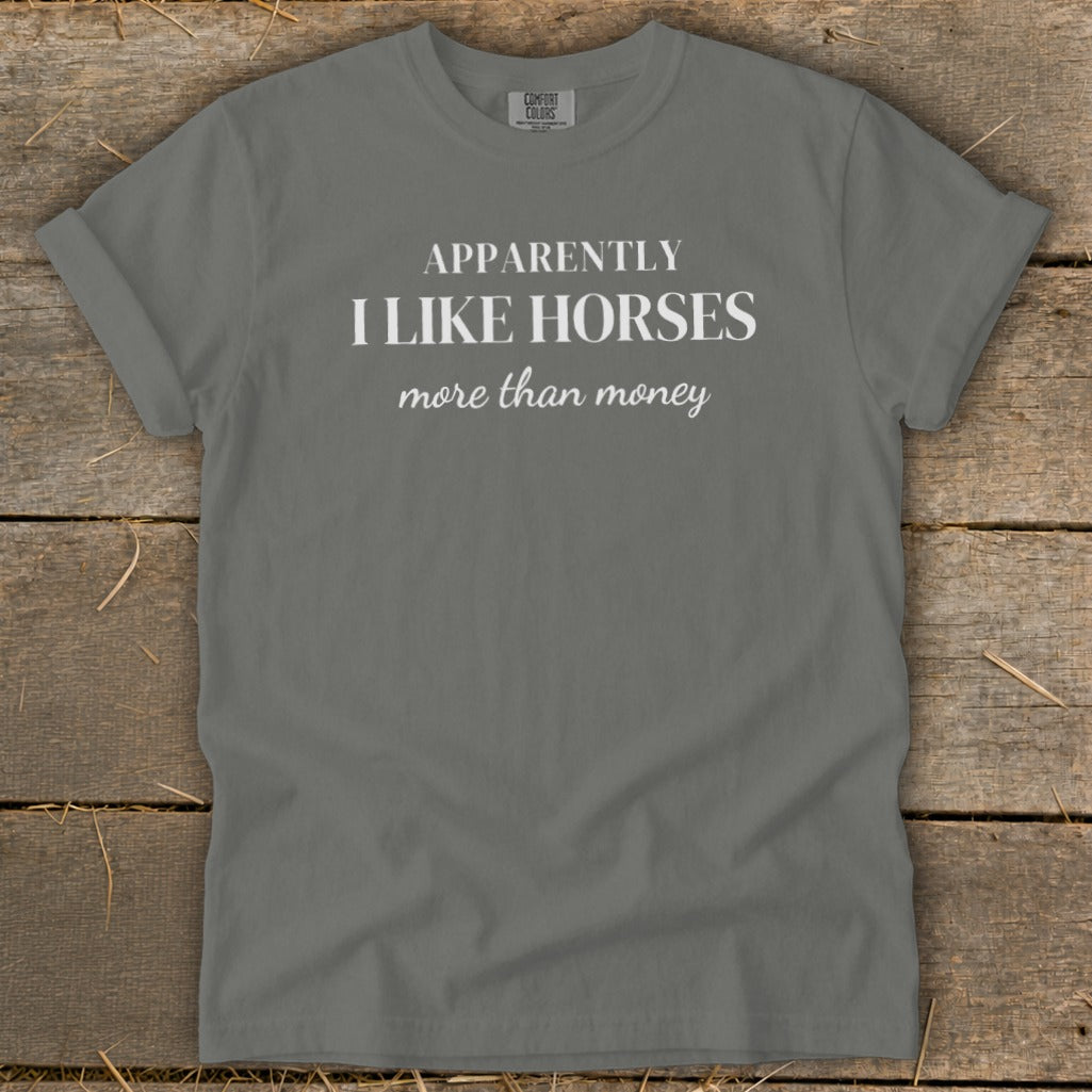 Gray t-shirt with white text that reads "APPARENTLY I LIKE HORSES more than money."