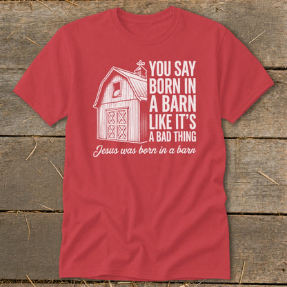 Red t-shirt with barn graphic and text about Jesus being born in a barn.