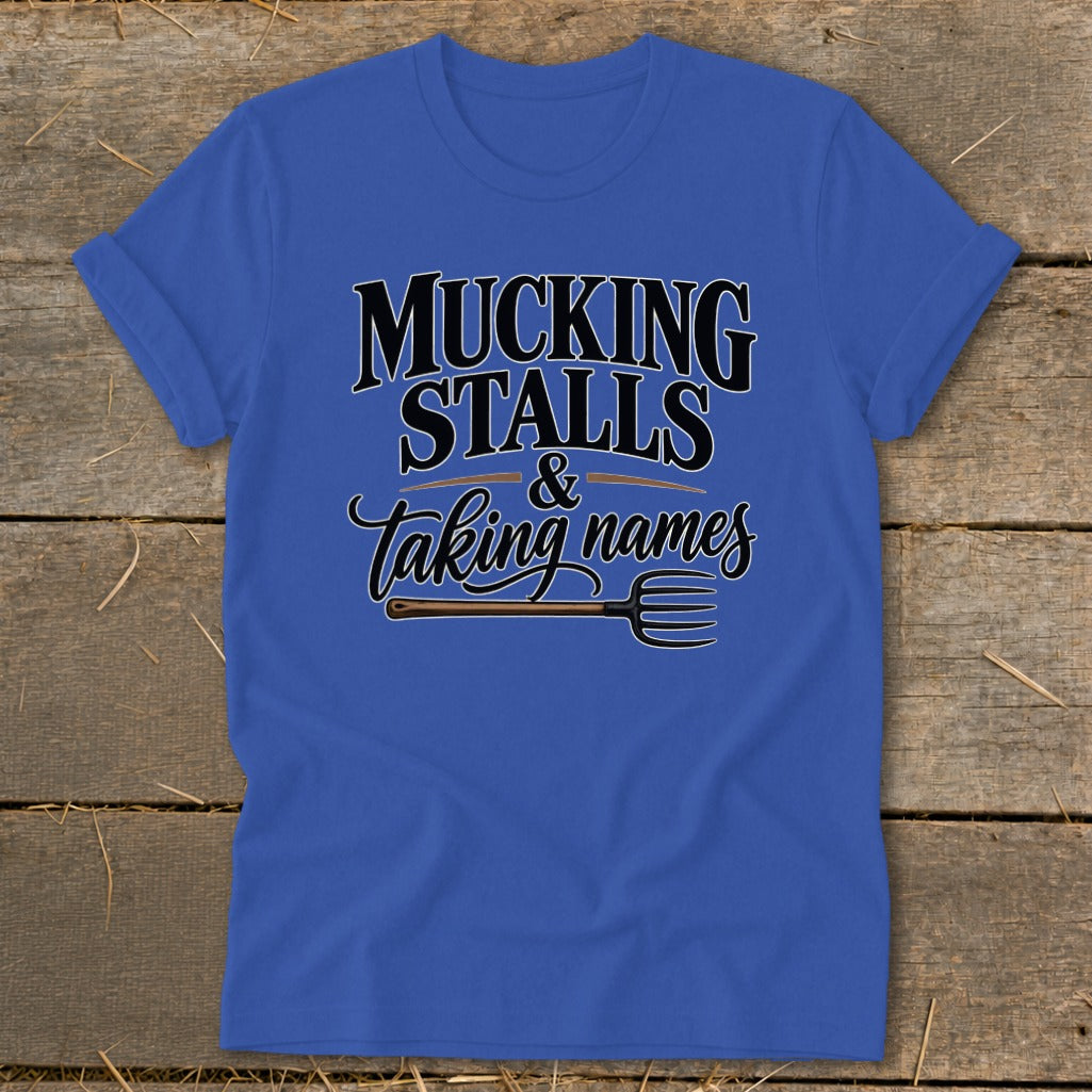 Royal blue t-shirt with "Mucking Stalls & Taking Names" text and a pitchfork graphic.