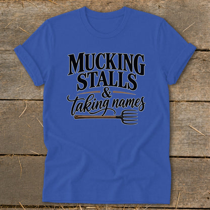 Royal blue t-shirt with "Mucking Stalls & Taking Names" text and a pitchfork graphic.