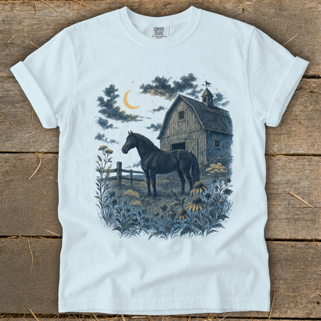 T-shirt graphic of a black horse standing by a barn under a crescent moon.