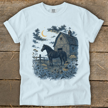 T-shirt graphic of a black horse standing by a barn under a crescent moon.