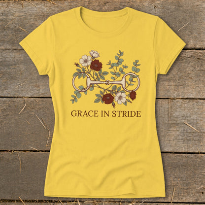 Yellow t-shirt with horse bit and floral graphic, text "GRACE IN STRIDE".