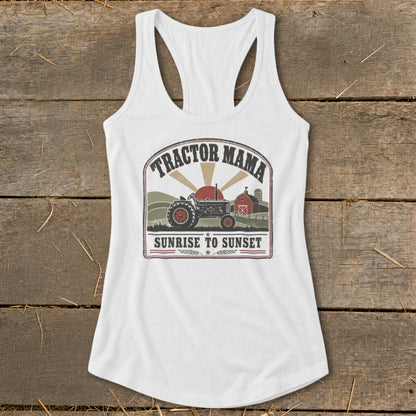White tank top with "Tractor Mama Sunrise to Sunset" graphic featuring a tractor and barn.