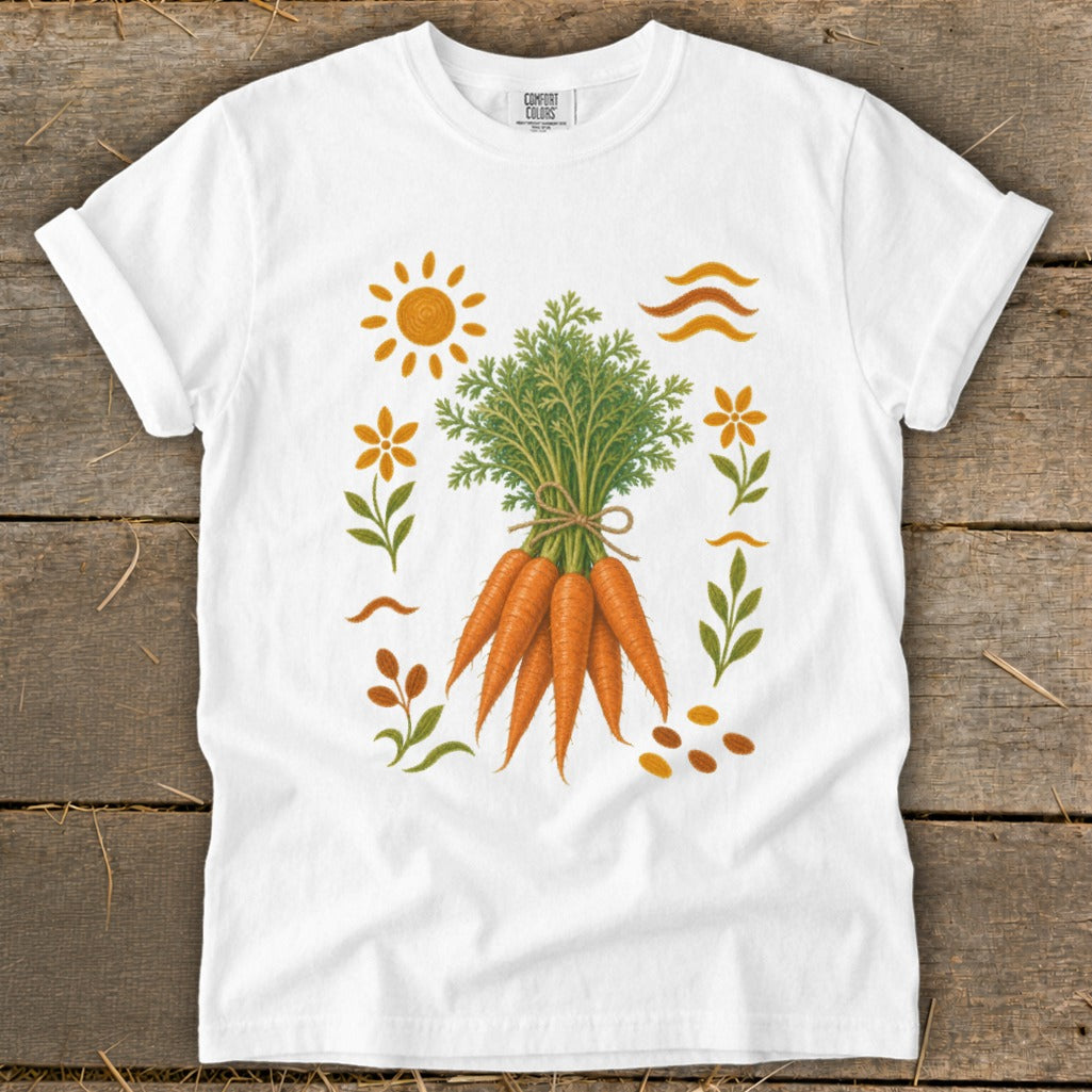 White t-shirt with a bundle of carrots surrounded by floral and sun motifs.