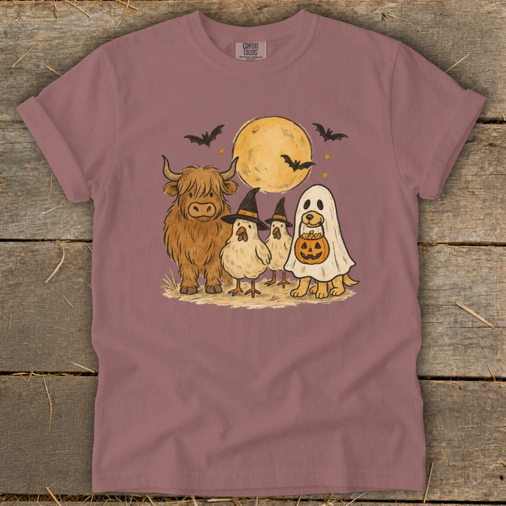 Highland cow, chickens, and dog in ghost costume with moon and bats.