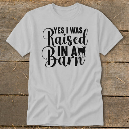 Grey t-shirt with black text reading "YES I WAS Raised IN A Barn" and a goat silhouette.