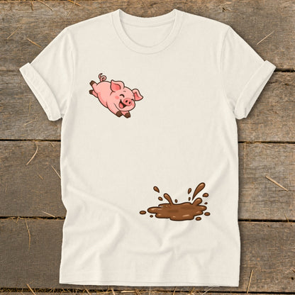 Cream t-shirt with a jumping cartoon pig and a splash of mud.