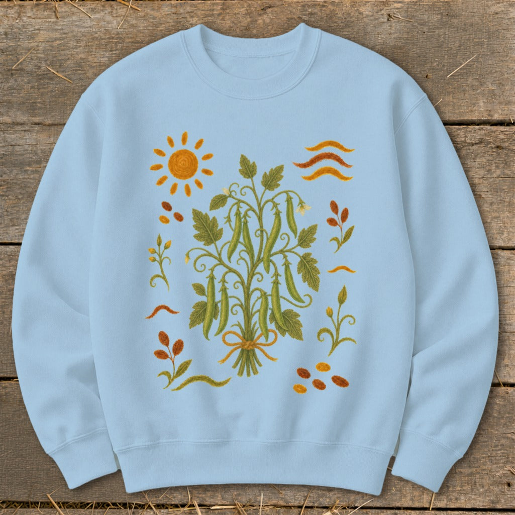 Light blue sweatshirt with a botanical pea plant and sun graphic.