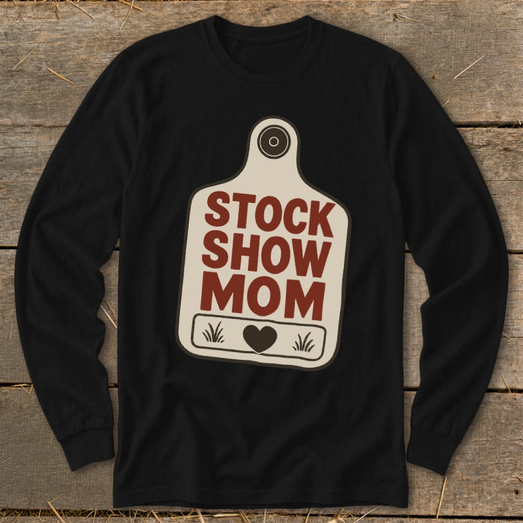 Black long-sleeve shirt with "STOCK SHOW MOM" text on a cream-colored tag.