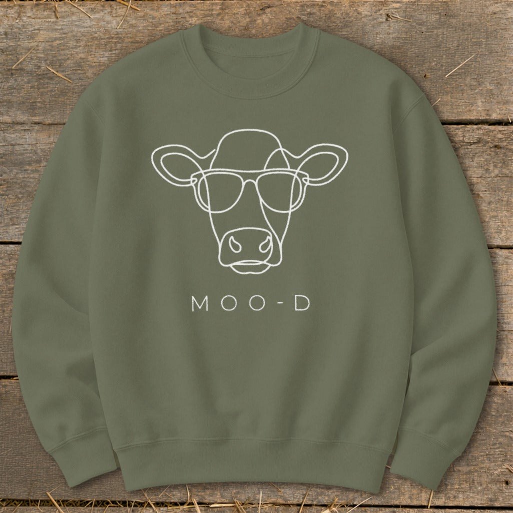 Olive green sweatshirt with white line art of a cow wearing sunglasses and the text MOO-D.