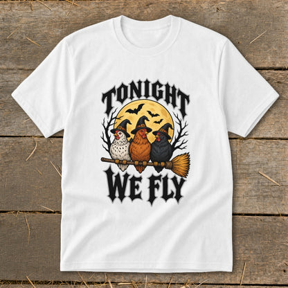 White t-shirt with three chickens in witch hats on a broomstick with text "Tonight We Fly".