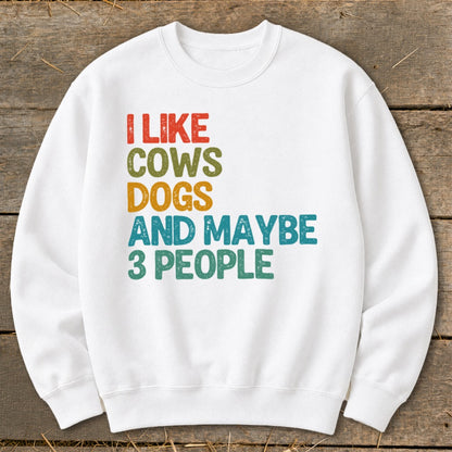 White sweatshirt with "I Like Cows Dogs and Maybe 3 People" text.