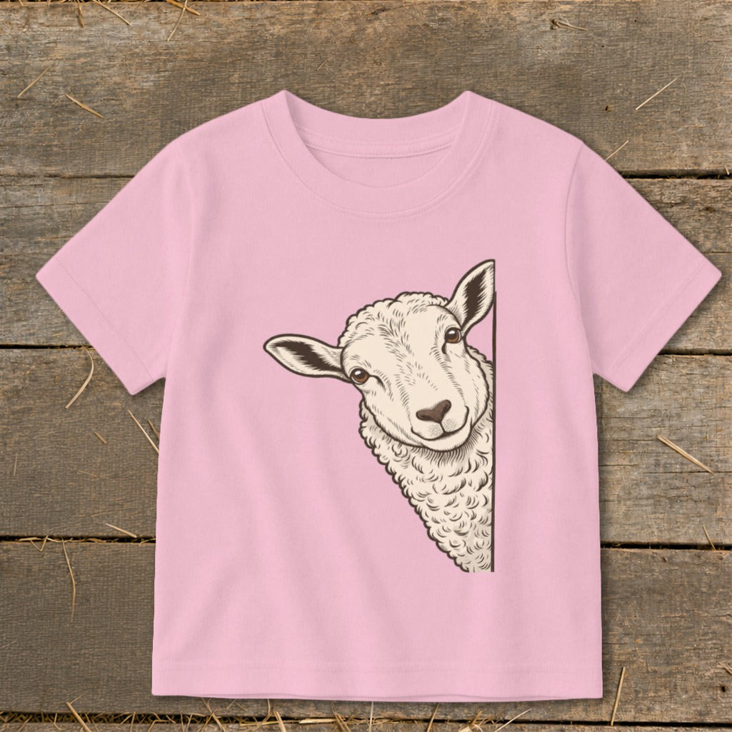 Pink t-shirt with a peeking sheep illustration on the left side.