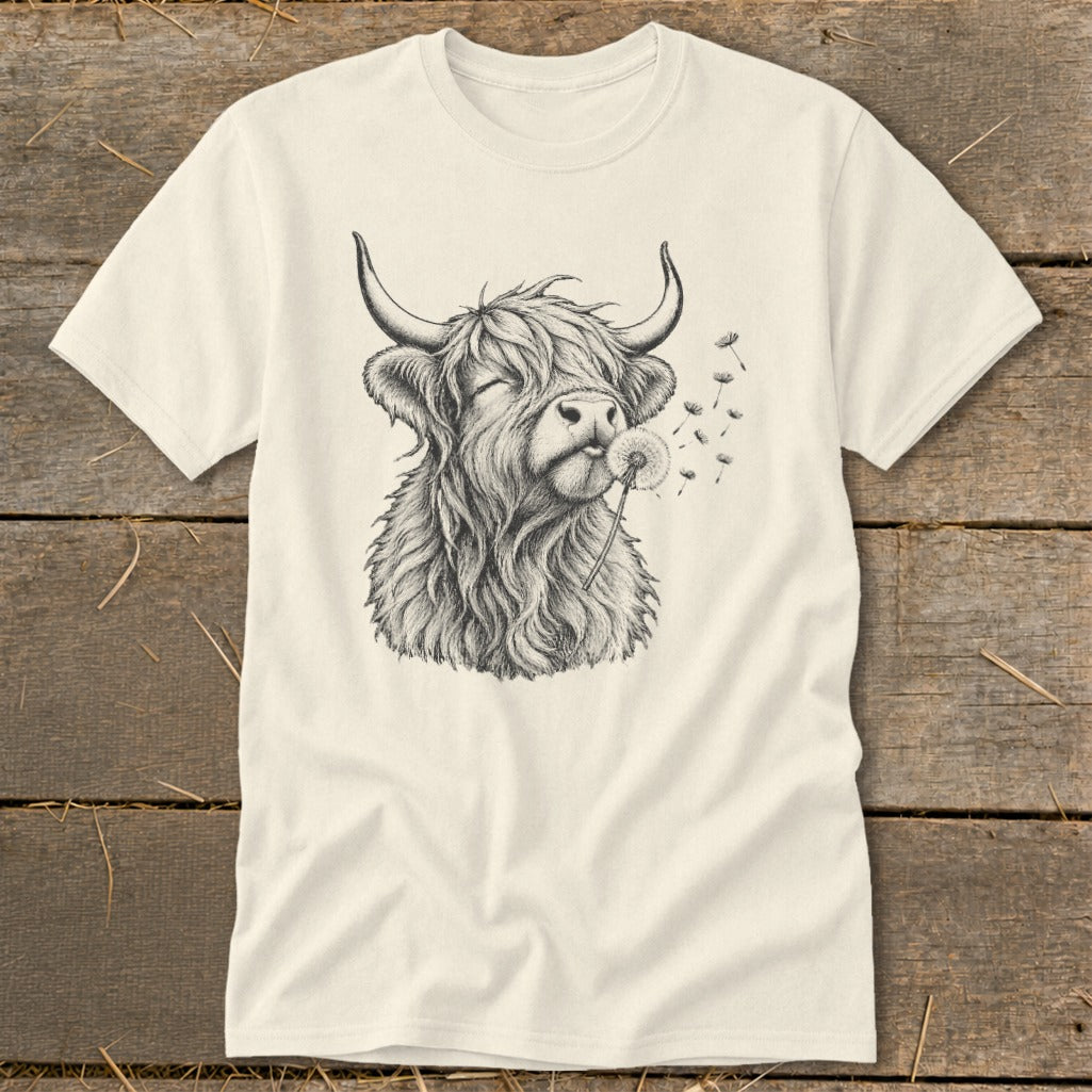 T-shirt with sketch of Highland cow blowing a dandelion, seeds flying.