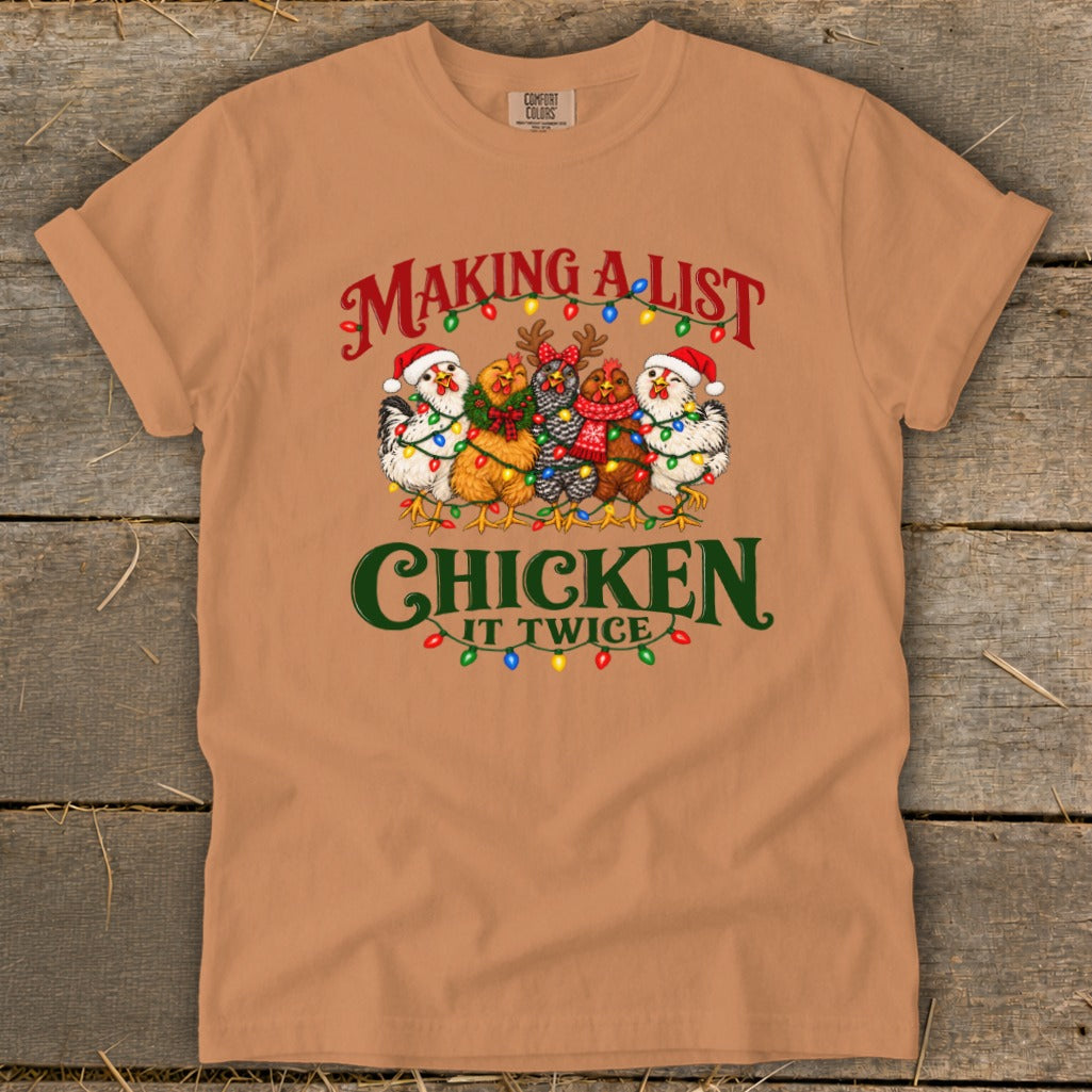 T-shirt with "Making a List, Chicken It Twice" graphic featuring festive chickens.