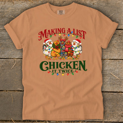 T-shirt with "Making a List, Chicken It Twice" graphic featuring festive chickens.