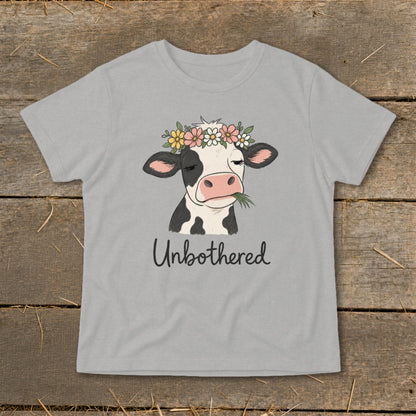 Grey t-shirt with a black and white cow wearing a flower crown and the text "Unbothered".