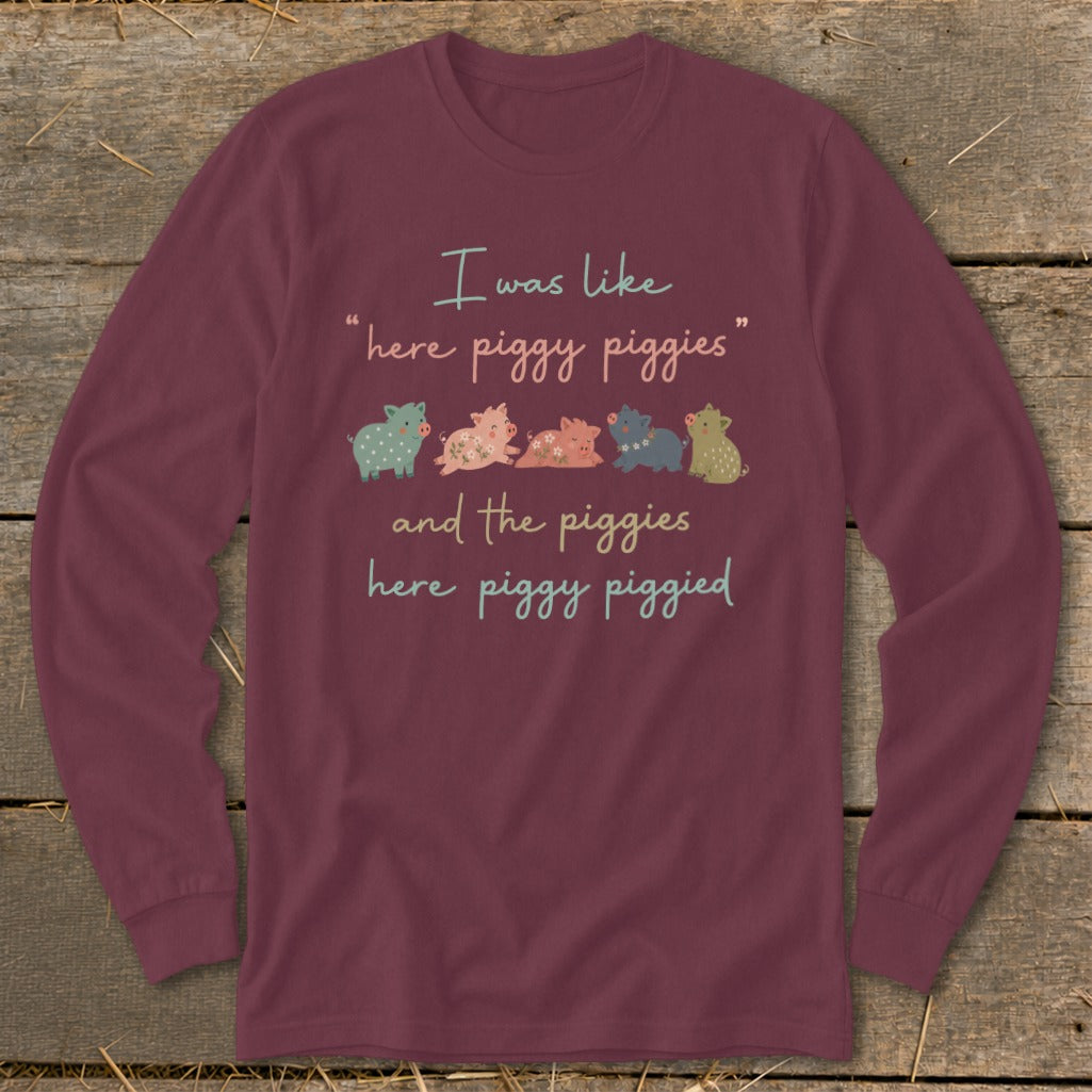 Maroon long sleeve shirt with text and cartoon pigs.