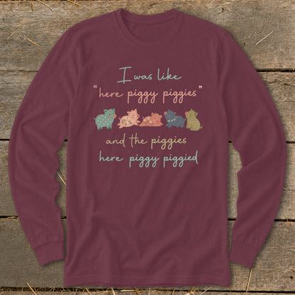 Maroon long sleeve shirt with text and cartoon pigs.