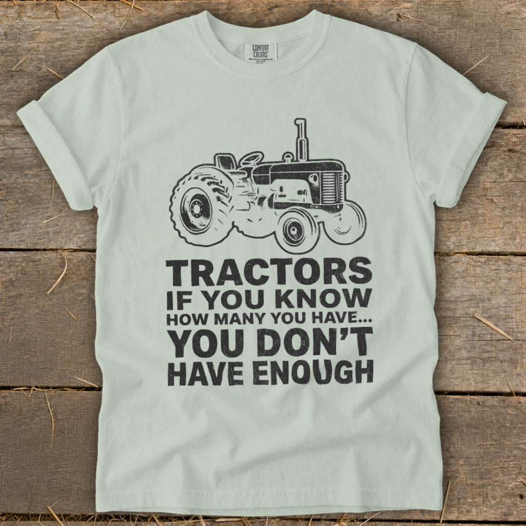 Light green t-shirt with a black tractor graphic and text about tractors.