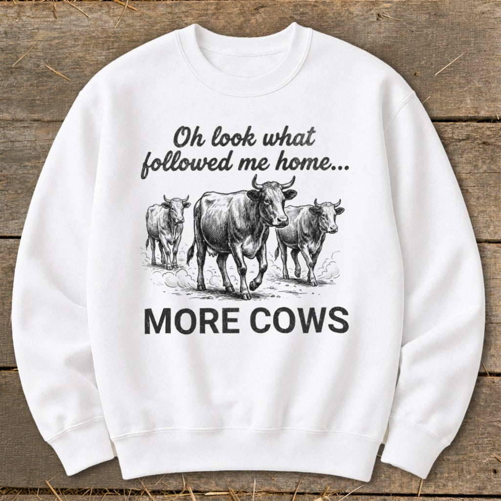White sweatshirt with three cows and text "Oh look what followed me home... MORE COWS".