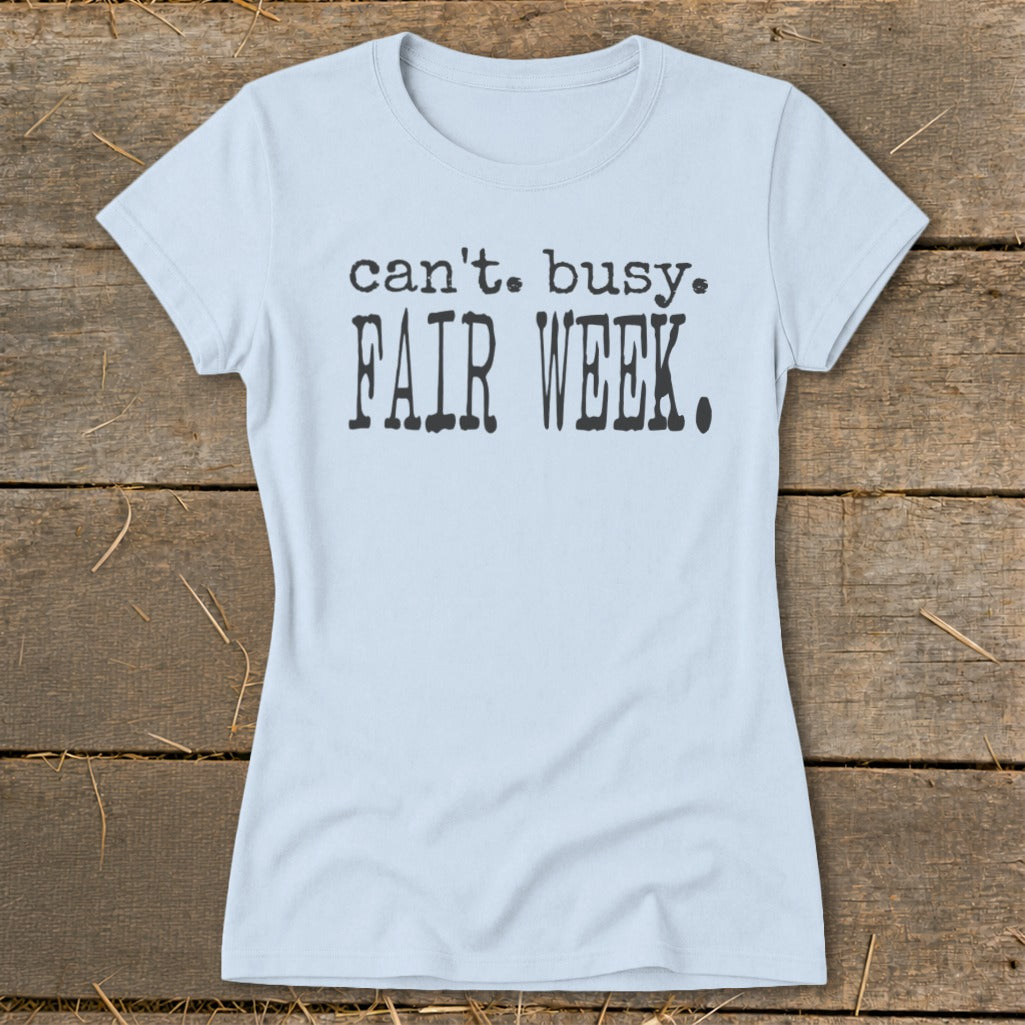 Light blue t-shirt with black text saying "can't. busy. FAIR WEEK."