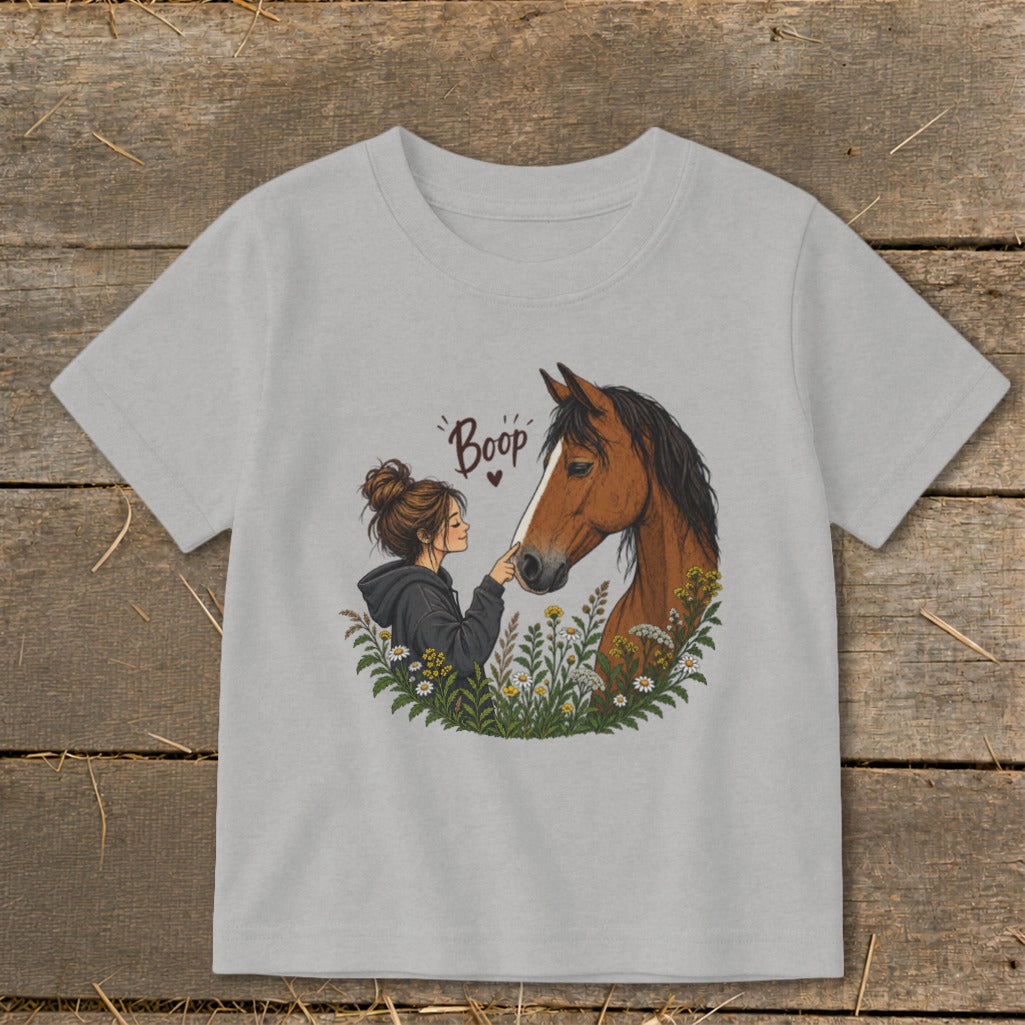 Girl gently touching a horse's nose with "Boop" written above.
