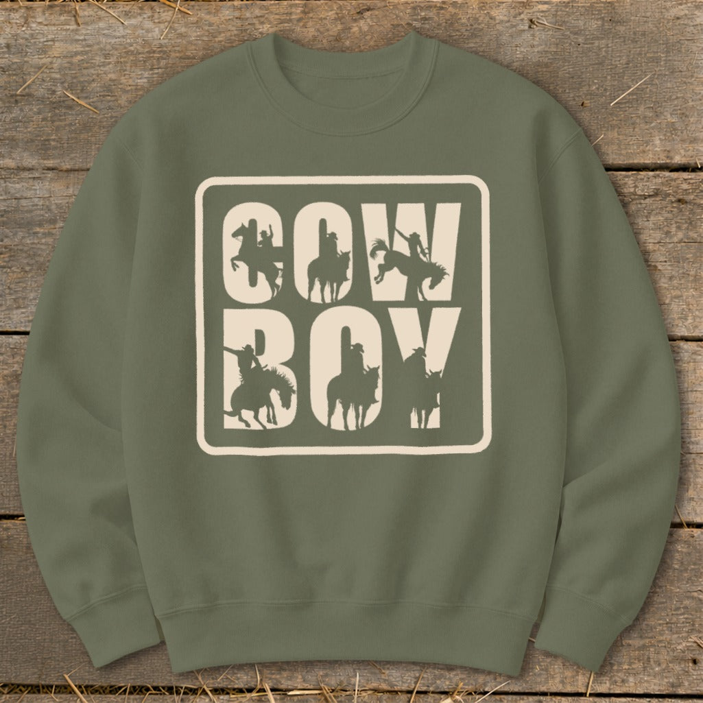 Olive green sweatshirt with "COW BOY" text and cowboy silhouettes within a bordered square.
