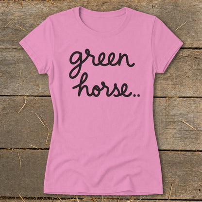 Pink t-shirt with "green horse.." text in black cursive font.
