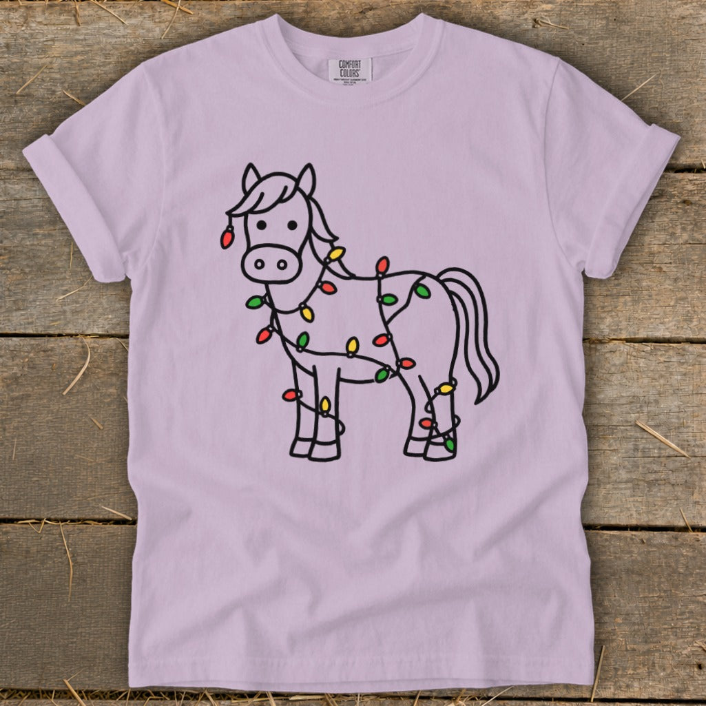 Lavender t-shirt with a black outline drawing of a horse wrapped in colorful Christmas lights.