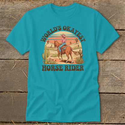 Turquoise t-shirt with desert scene and text "World's Okayest Horse Rider".