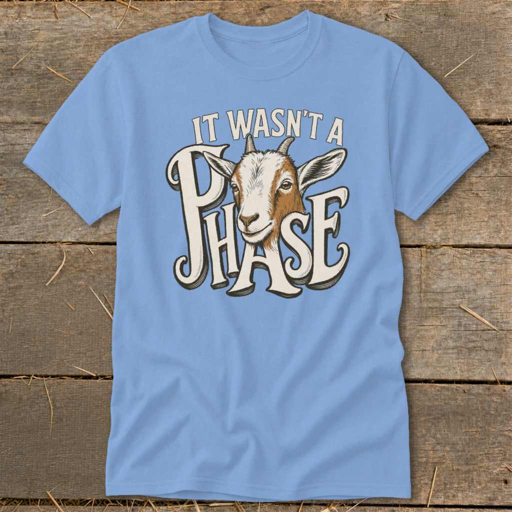 Light blue t-shirt with a goat and "IT WASN'T A PHASE" text design.