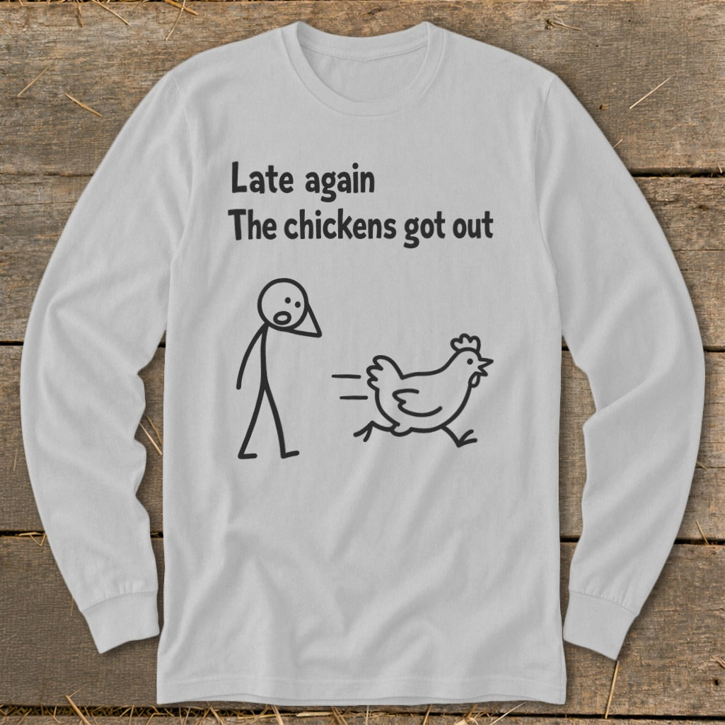 White long-sleeve shirt with text "Late again The chickens got out" and stick figure chasing a chicken.
