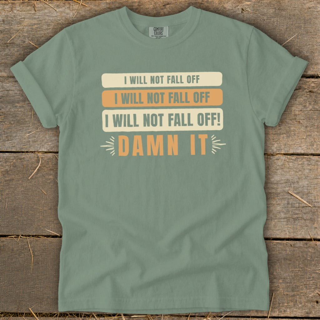 Green t-shirt with repeating text "I WILL NOT FALL OFF" and "DAMN IT".