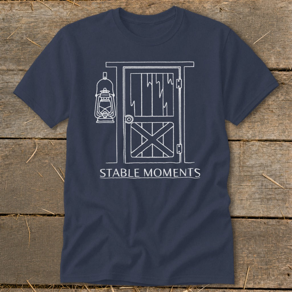 Navy t-shirt with white line drawing of stable door, lantern, and text "STABLE MOMENTS".